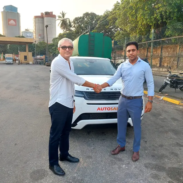 A handshake as an Autosafe customer takes delivery of their car